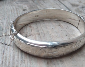 Vintage sterling silver hinged bangle with safety chain
