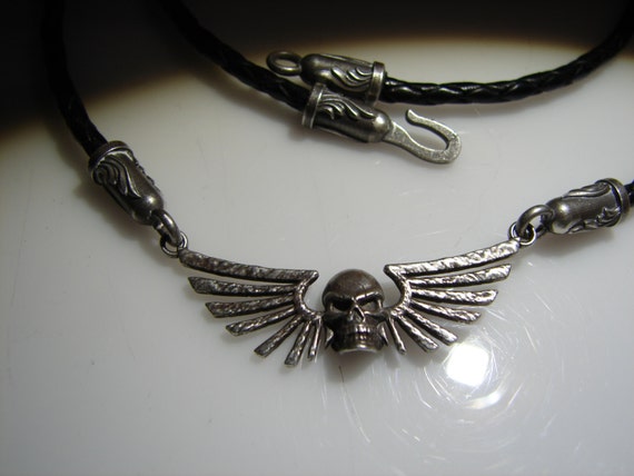 Gothic, Dark Angel skull and wing necklace. This custom design features a braided leather necklace with custom made findings.