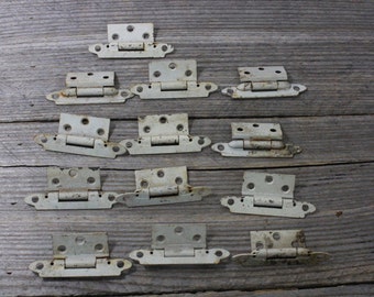 Set of 13 vintage metal cabinet hinges...circa 1950s
