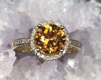 Orange zircon and diamond halo ring