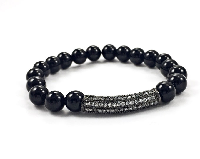 Fashionable! Black onyx 8mm beaded stretch bracelet with a polished pave crystal bar for a touch of sparkle.