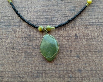 Handmade beaded necklace with green polished stone pendant