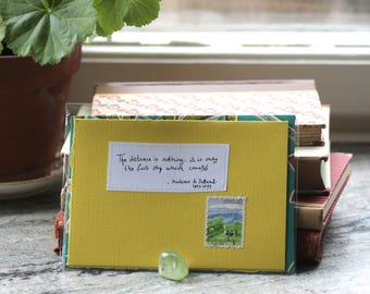 The distance is nothing it it only the first step which counts Yellow card with handwritten quote and Japanese postal stamp