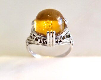 Circa 1930. Cabochon Citrine set in 14KT white gold Art Deco Mounting