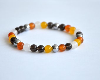 White and yellow jade, orange agathe, hematite and quartz bracelet. 6mm beads.