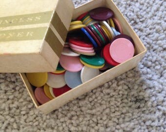 A Large Assortment of Grooved Plastic Discs in a Box