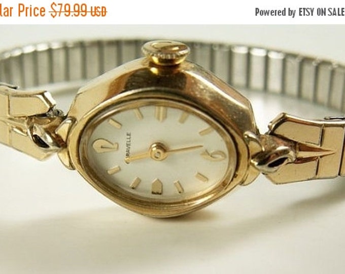 Storewide 25% Off SALE Lovely Vintage Ladies Caravelle Designer Mechanical Gold Tone White Dial Watch Featuring Twist-A-Flex Adjustable Band