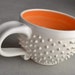 Spiky Coffee Mug Ready To Ship White and Orange Dangerously Spiky Cocoa Soup Mug by Symmetrical Pottery