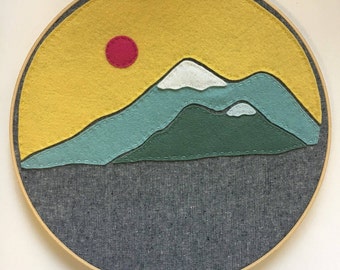 Embroidery Hoop Art, Wall Art, Felt, Mountains, Mountain Range, Yellow, blue, green, and pink sun with grey linen