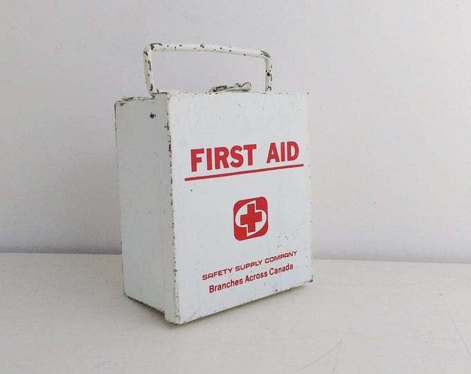 Small vintage first aid box, white and red metal travel box by the Safety Supply Company