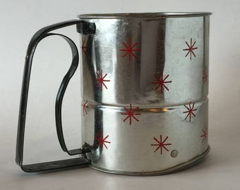 Vintage Made in U.S.A. Androck tin flour sifter with red stars with black squeeze handle