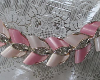 A vtg. pink and white thermoset bracelet with silvertone finish--6-1/2" x 1-1/2" wide--from the 70s