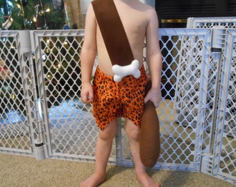 Bam Bam Costume option of club size 0-3 months through size 6 includes shorts, bone and strap option of club
