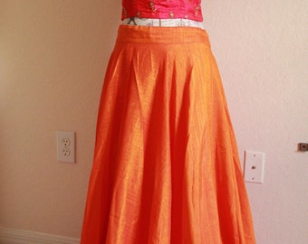 A Orange Lehanga with Pink Crop Top .