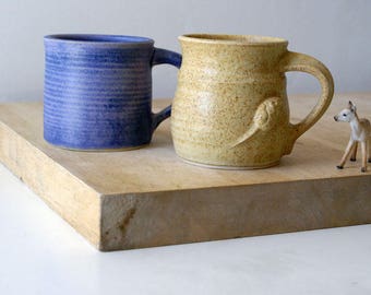 Two mismatched mugs - glazed in lavender blue and natural brown