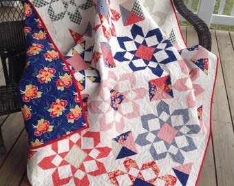 Starburst quilt, reds and blues with blue backing, 67"x67"