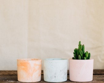 Mixed trio of coloured cement vessels, mini planter, cement tealight holder