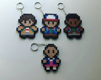 Hand made Stranger Things perler bead keychains featuring Eleven, Will, Dustin and Lucas