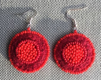 Textile, cherry-red earrings, scarlet brightness.