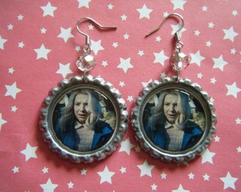 Eleven with blonde wig close up Stranger Things bottle cap earrings with clear faceted glass beads