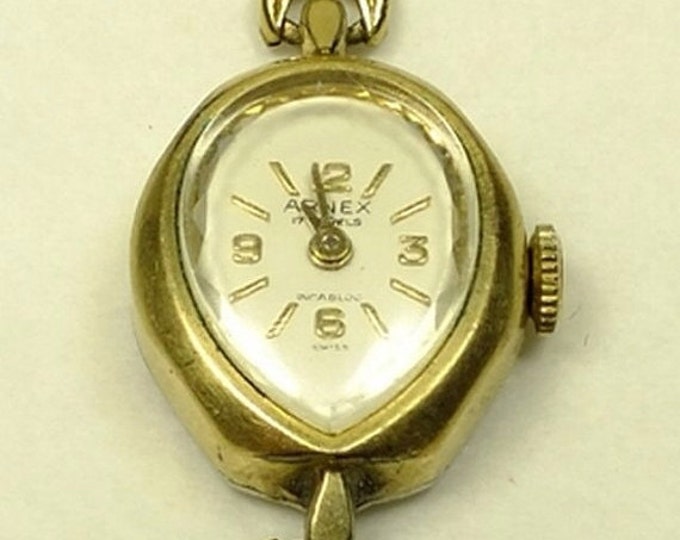 Storewide 25% Off SALE Vintage Ladies Arnex 17 Jewels Incabloc Swiss Made 10k Gold Watch featuring a flush set black & rhinestones on the li