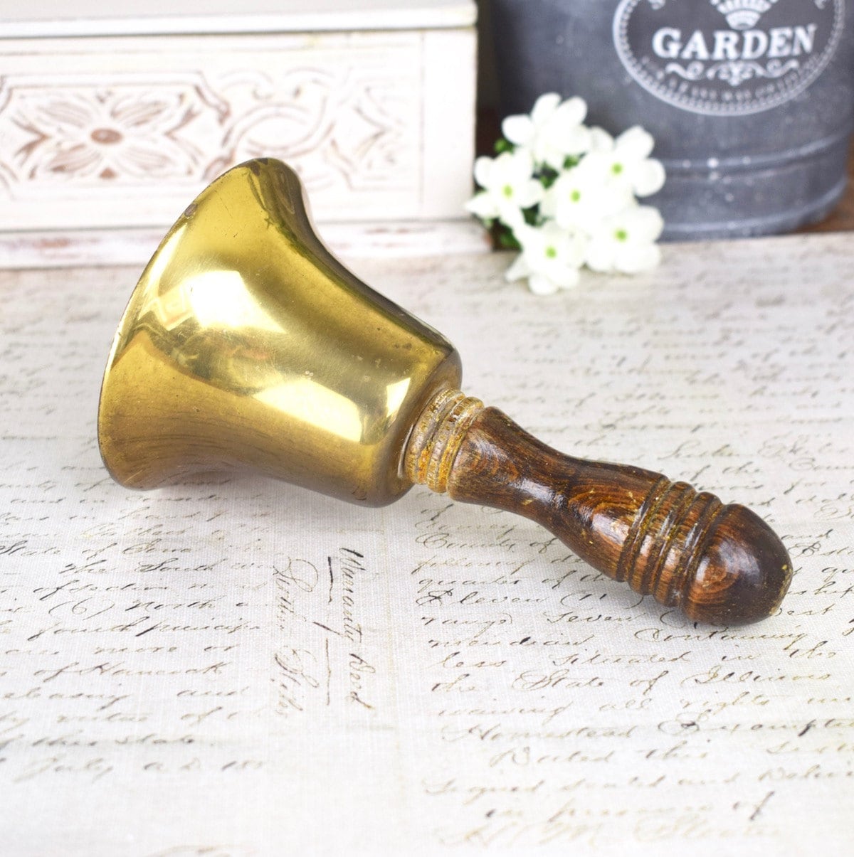 small vintage hand bell brass bell with wooden handle.