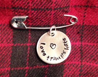 Safety pin with "Love Trumps Hate" bangle/pendant