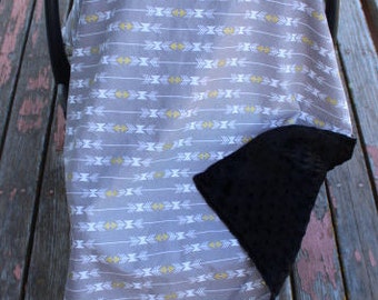 baby car seat cover 40 x 31, gray with white and gold arrows, black dot minky on the inside of cover, attaches to car seat with velcro