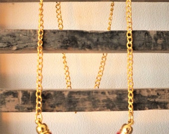 Purple knitting wool and brass necklace