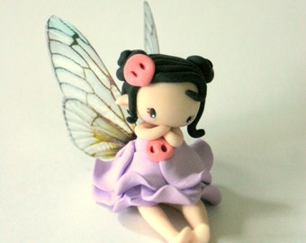 fairy on a swing figurine