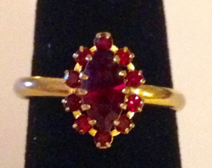 Storewide 25% Off SALE Vintage Gold Tone Prong Set Red Ruby Rhinestone Designer Cocktail Ring Featuring Rosette Artistic Design With Adjusta