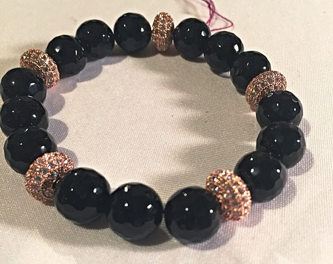 Pave crystals ignite this statement making beaded bracelet! 10mm faceted black agate stones on a stretchable cord bracelet.
