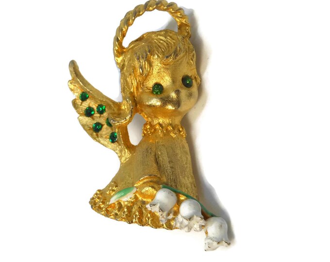 MYLU cherub brooch, book piece, gold tone, angel brooch pin, girl with green rhinestone eyes and wing accents, carrying lily of the valley