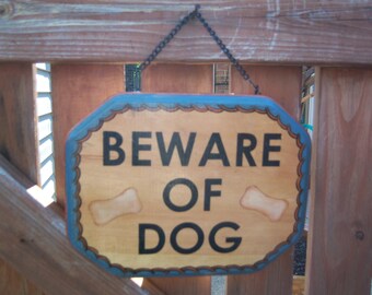 Beware of Dog Sign Painted on Wood with Rust and Blue Colors and Bones