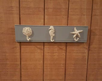 thumbnail interactive-video image 1 of Nautical Sand Dollar Wall Hook – Beach Shore Decor, Verdigris Green Finish, Cast Iron 1 of 5