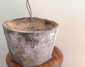 Rustic riveted galvanized and stone bucket