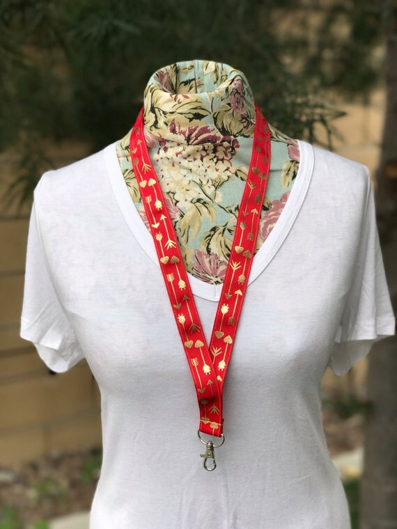 Red ribbon lanyard with gold arrows arrow lanyard follow