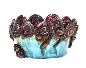 Beautiful multicoloured hand thrown bowl with coiled decoration.
