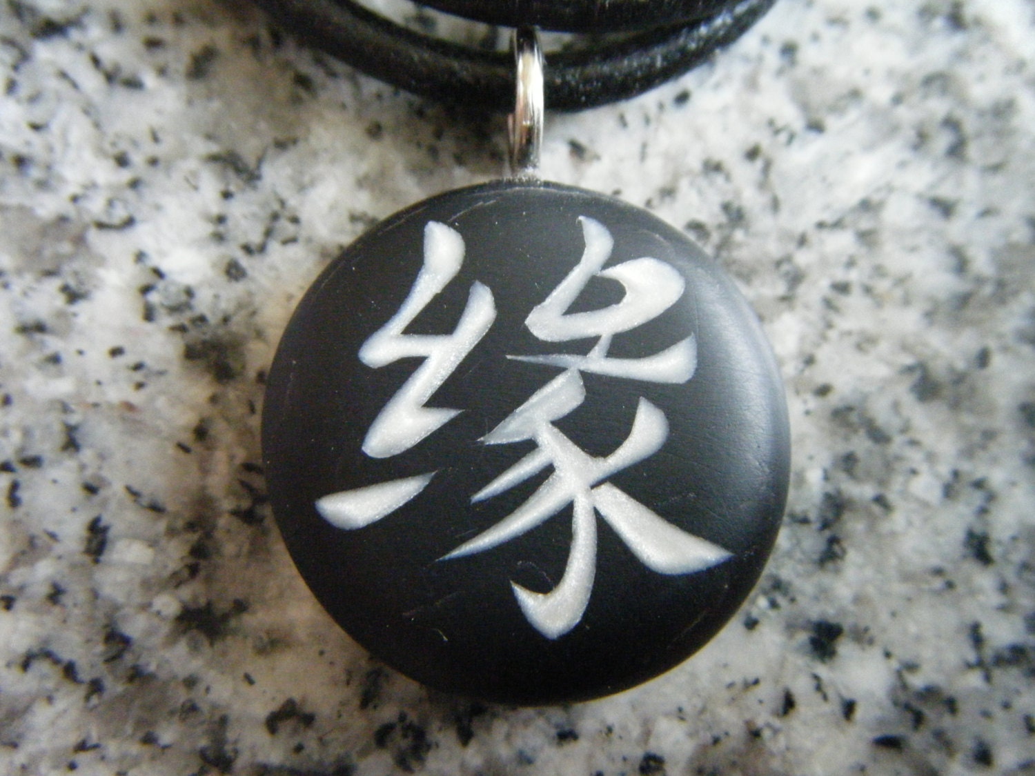 Japanese kanji KARMA symbol hand carved on a