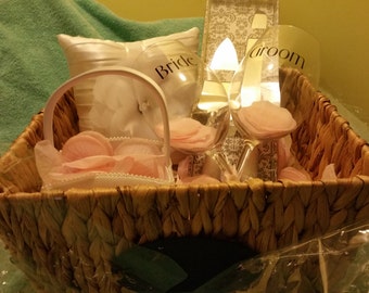 Everything a bride needs cake cutter.wine glasses, ring bearer pillow and flower girl basket