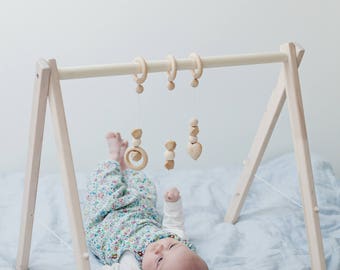 Disassembled wooden baby gym, no hangers, only frame + three wooden rings