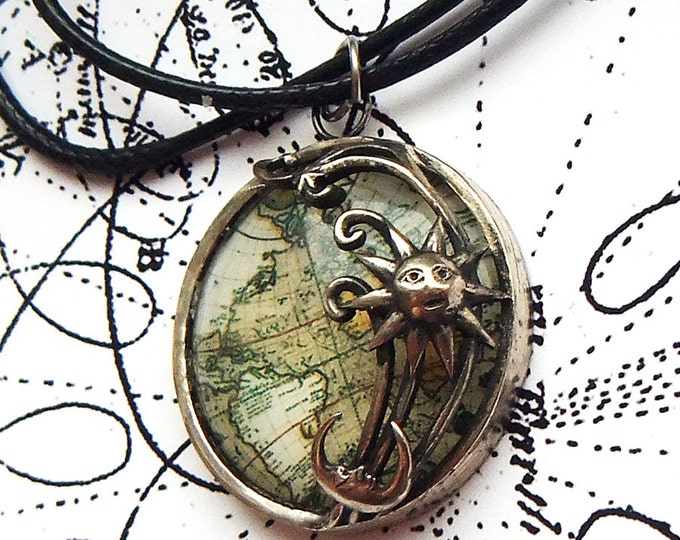 Pendant "Sun and Moon over the land" made of bronze with a glass lens