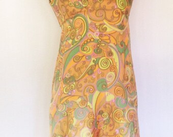 Vintage multicolor silk gown with geometric swirl design. Sleeveless with cape flaps at shoulder, empire waist and flared skirt