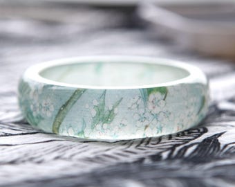 Resin bangle with embedded Asian floral art