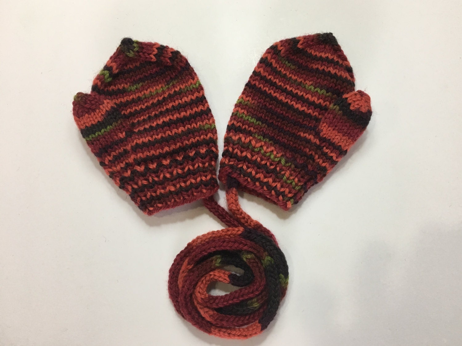 Hand knitted wool baby mittens with thumb and string size