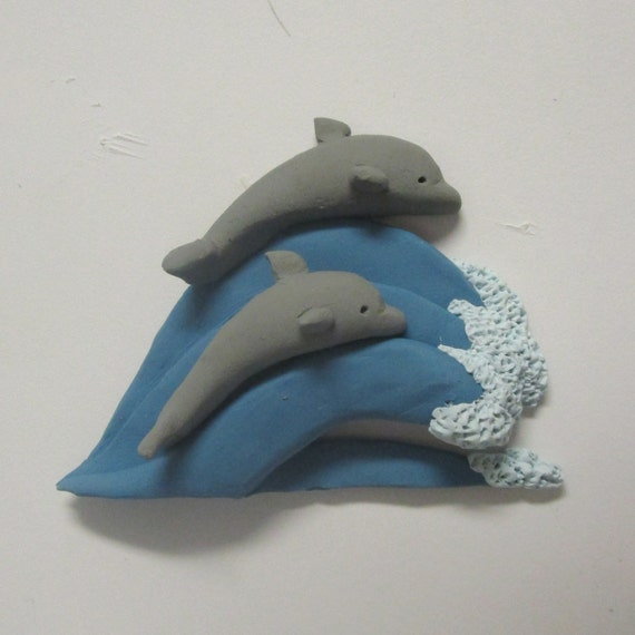 Items similar to Dolphins on Wave Clay Handmade Dolphin