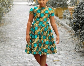Child in wax, cloth dress African