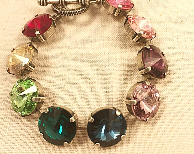 Amazing! Candy rainbow rivoli Swarovski® crystal bracelet with a toggle clasp. Put a colorful finish on any daytime or evening look.
