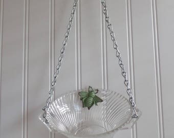 glass bird feeder with bee