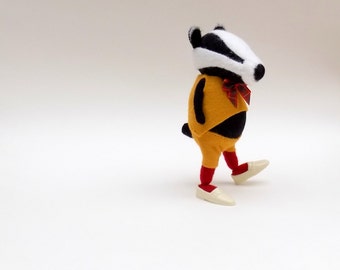 Woollen Badger - Handmade plush badger wearing red woolly tights and yellow felt suit with tartan bow.